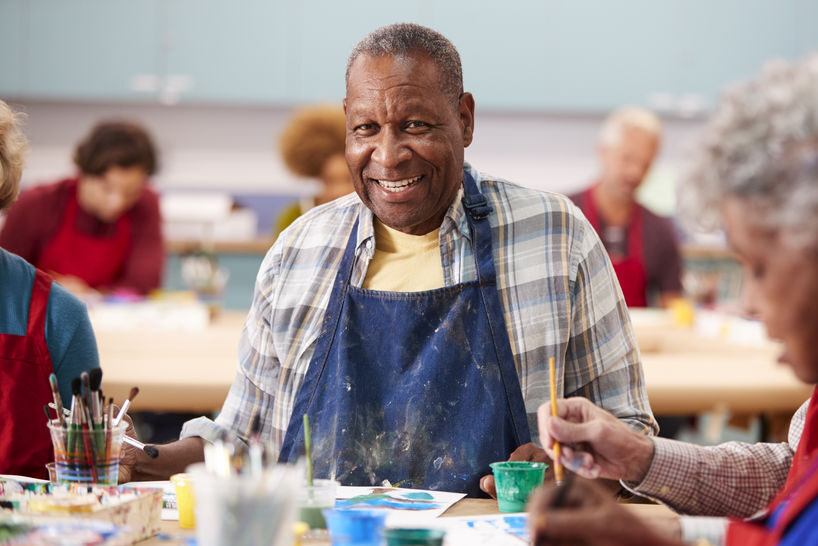 Portrait Of Retired Senior Man Attending Art Class In Community Centre Area Agency on Aging of